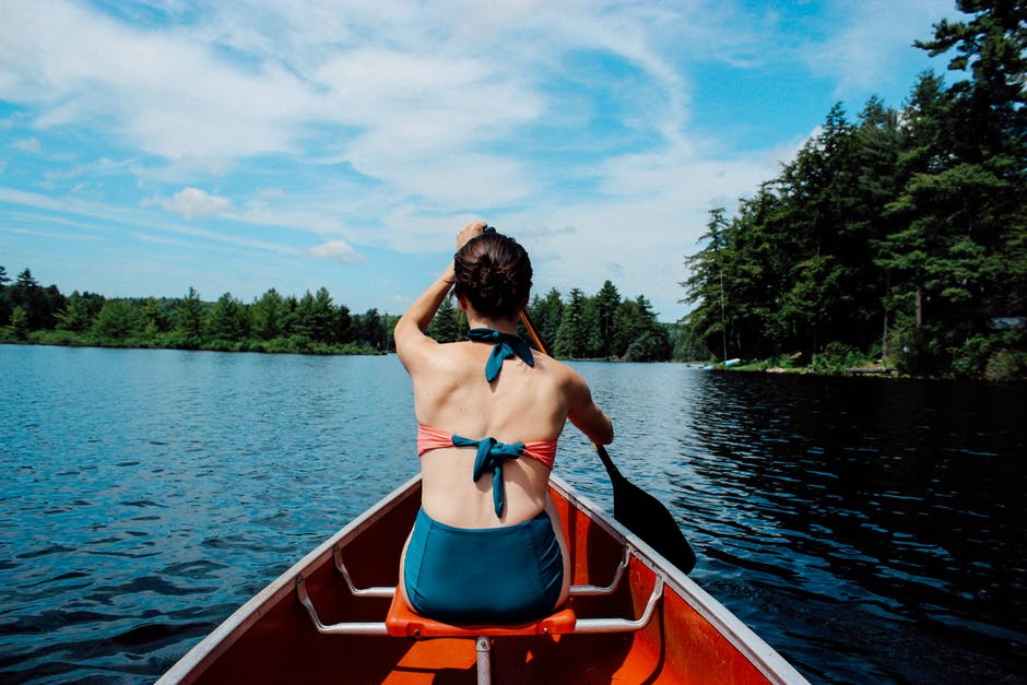 Woman rowing in canoe